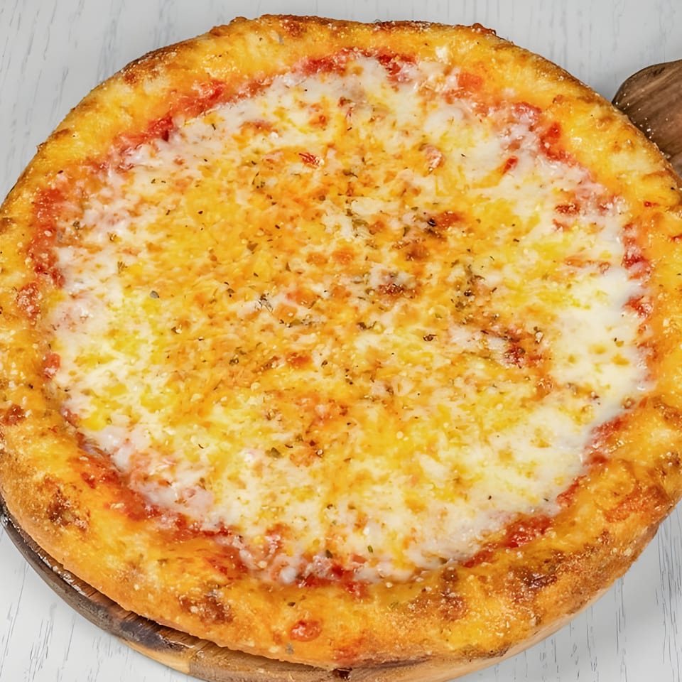 A whole cheese pizza from Pizza Station, with a golden crust and melted mozzarella, on a wooden board.